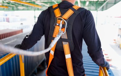 Construction worker use safety harness and safety line working on a new construction site project.